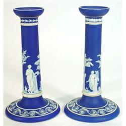 Pair of Victorian Wedgwood dark blue and white Jasperware candlesticks, decorated with maidens am…