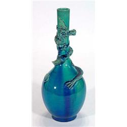 Turquoise glazed Chinese slender necked vase, decorated in relief with a dragon crawling the neck…