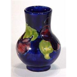 Moorcroft baluster vase, hand decorated with pansies onto a blue ground, impressed marks to base,…