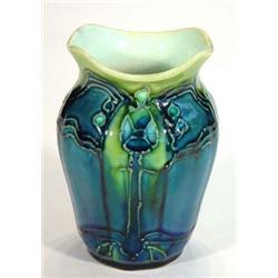 Mintons Successionist vase, decorated with tube lined flowers onto a blue and green ground, impre…