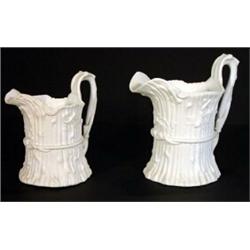 Two Victorian Parian jugs moulded with branches and ivy, lozenge marks to bases, largest 23cm hig…