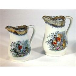 Two Victorian pottery jugs, transfer printed and hand coloured with urns and flowers, largest 17c…