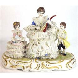 Hand painted continental porcelain figure group of a lady playing mandolin and children in a lace…