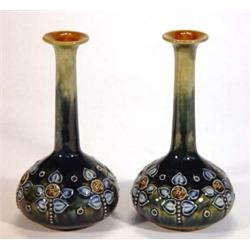 Pair of slender necked Doulton Lambeth stoneware vases, decorated with a band of stylized flowers…