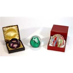 Boxed facet cut purple glass paperweight, boxed multi coloured twisted glass paperweight and a bu…