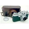 Image 1 : A Leica IIIc camera, No.493911 with an Elmar 3.5/5cm lens in leather travelling case,...