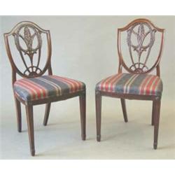 A set of eight 19th century Hepplewhite design mahogany dining chairs, the shield shape backs wit...