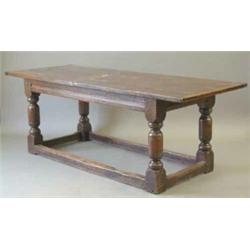 An early 17th century design oak refectory table, with four plank top on turned column legs, with...