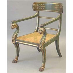 A Regency green painted and parcel gilt elbow chair in the manner of Thomas Hope, with wide curve...