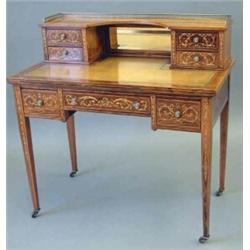 An Edwardian inlaid rosewood writing desk, with brass galleried bank of four small drawers, toole...