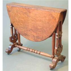 A Victorian figured walnut Sutherland table with oval top on pierced standard ends fitted brass c...