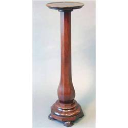 A mahogany torchere, octagonal baluster stem and stepped platform on bun feet, height 3ft.7ins....