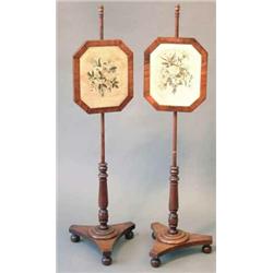 A pair of Victorian mahogany pole screens, with floral embroidered silk panels on turned stems an...