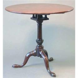 A George III mahogany circular occasional table, with bird cage, and tapered stem with spiral flu...
