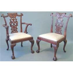 A set of eight reproduction mahogany dining chairs, (including two with arms), with carved and pi...