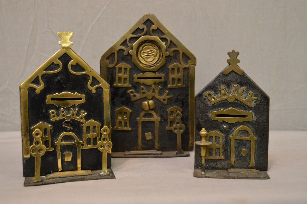 Three antique cast metal coin banks