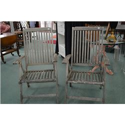 Two weathered wooden Parisian style folding deck chairs