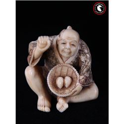 Antique Japanese ivory netsuke figure holding two eggs