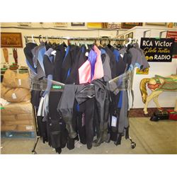 Rack full of new Bare wet suits