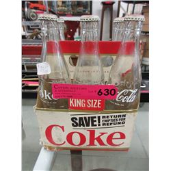 Glass Coke bottles in cardboard  carriers