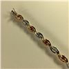 Image 2 : ONE 10KT WHITE GOLD AND YELLOW GOLD DIAMOND & RUBY LINK BRACELET.  SET WITH 9 ROUND BRILLIANT