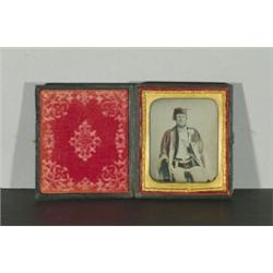 [Cased Image], A quarter plate ambrotype of a seated gentleman wearing robes, cap and apron, th...