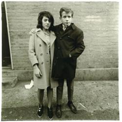 Arbus, Diane (1923-1971), TEENAGE COUPLE ON HUDSON STREET, N.Y.C., 1963, a silver gelatin print...