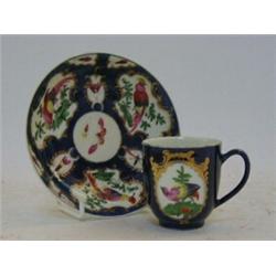 A MATCHED WORCESTER COFFEE CAN AND SAUCER, c.1760, exotic birds in cartouches on blue scale groun...