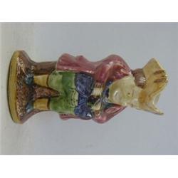 A SEATED TOBY JUG, 19th Century, yellow hat, crimson jacket and blue waistcoat, height 25cm  50-8...