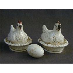 A PAIR OF NOVELTY STAFFORDSHIRE CONTAINERS, 19th Century, hens seated on a nest, painted and gilt...