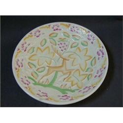 A CROWN DEVON ART DECO CHARGER, leaping gazelle in relief surrounded by stylized foliage highligh...