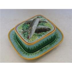 A GEORGE JONES MAJOLICA SARDINE DISH, cover and stand, c.1870, fish finial on a bed of water foli...