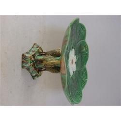 A MAJOLICA COMPORT, c.1880, formed as three storks beneath a waterlily, on an incurved triangular...