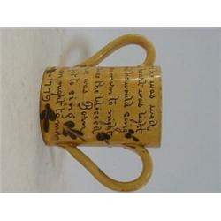 AN EXETER ART POTTERY TWIN HANDLED MUG, late 19th Century, slip sunflower motif and motto with da...