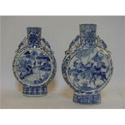 A PAIR OF ARITA TYPE MOONFLASKS, one with battle scenes, the other water buffalo, height 25cm (2)...