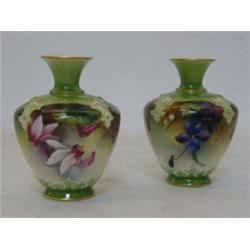 A PAIR OF ROYAL WORCESTER BOTTLE VASES, 1905, florally painted panels within a raised gilt lined ...