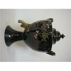 A BLACK GLAZED WATER URN, and cover, late 19th Century, over-enamelled and gilt floral decoration...