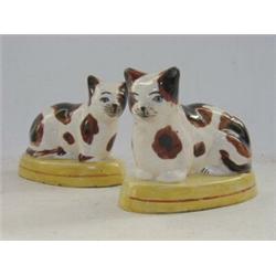 A PAIR OF SEATED CAT FIGURES, early 20th Century, brown and white, on oval plinths, height 11cm (...