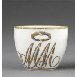 A Derby tea cup, - A Derby tea cup, enamelled with a large cursive monogram MM beneath a chaplet...