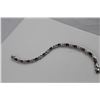 Image 2 : 6.00CT OVAL GARNET AND DIAMOND FIGURE 8 LINK BRACELET. INCLUDES $550 CERTIFICATE
