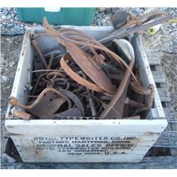 Wood box full of antique farm parts