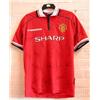 A rare Manchester United home shirt signed by members of the squad at...
