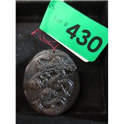 Carved stone pendant with dragon motif