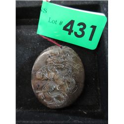 Carved stone pendant with dragon motif