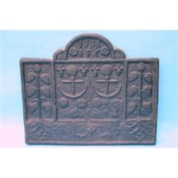 A 16th century cast iron fireback, the arched top with date letters '1588' above two stylised anc...
