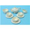 A Belleek shell-moulded part tea service, comprising:- teapot, sugar bowl, slop bowl, three cups...