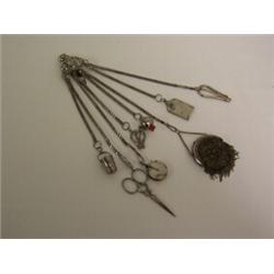 FRENCH CUT STEEL CHATELAINE, with eight chains holding thimble, scissors, pin cushions, cork screw,.