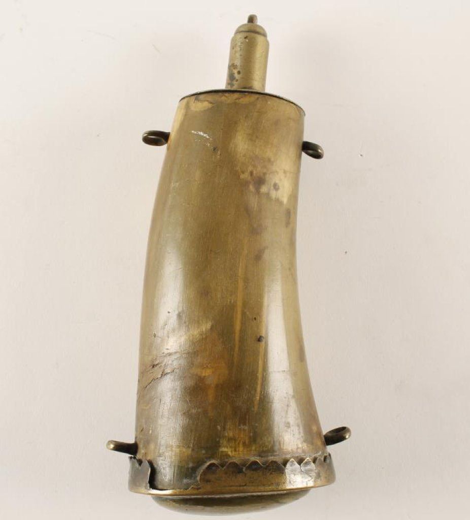 Large antique horn powder flask with brass mounts and four hanging rings;