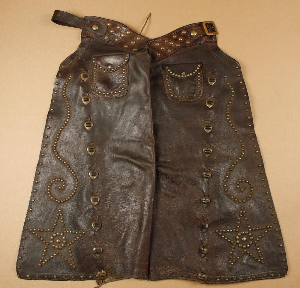 Pair of heavy duty leather working cowboy chaps with brass decoration and