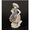 Image 2 : Lladro girl with flower basket, #5221; 7&#8221; in  height.     Est.:  $75-$150.